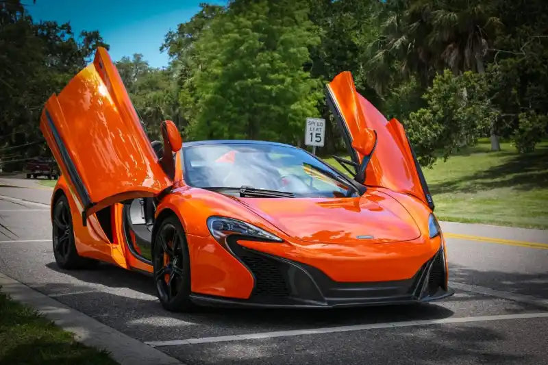 Stunning McLaren with doors open parked on street, representing McLaren rental cost Orlando.