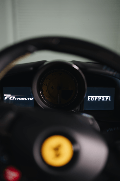 Interior view of the 2020 Ferrari F8 Tributo dashboard showcasing luxury design and engineering.
