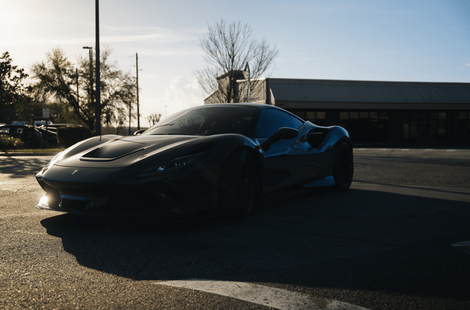 2020 Ferrari F8 Tributo parked in sunlight showcasing its luxury design and powerful stance.