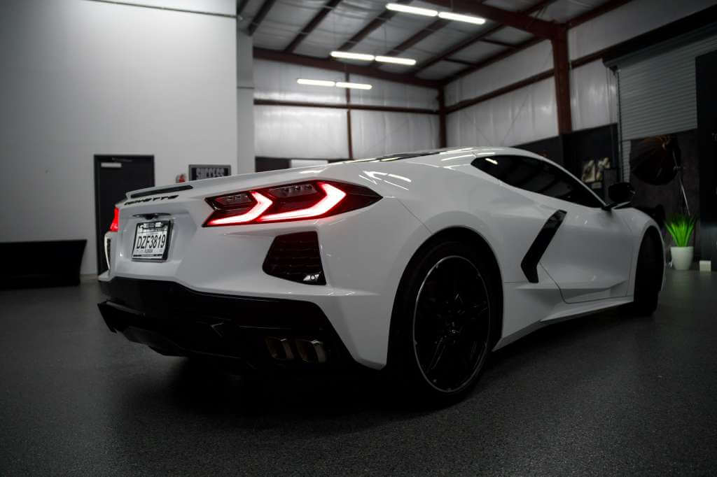 2023 Corvette C8 in Artic White showcasing sleek rear design and modern aesthetics.