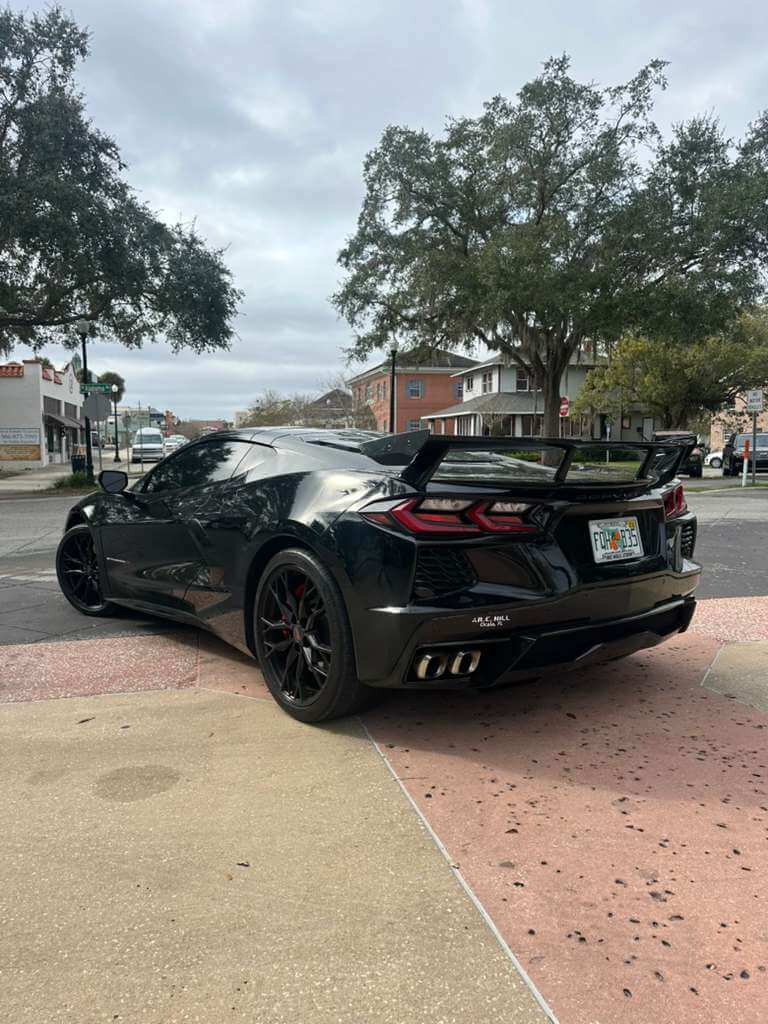 2023 Corvette C8 parked on the street showcasing its sleek design and powerful stance.