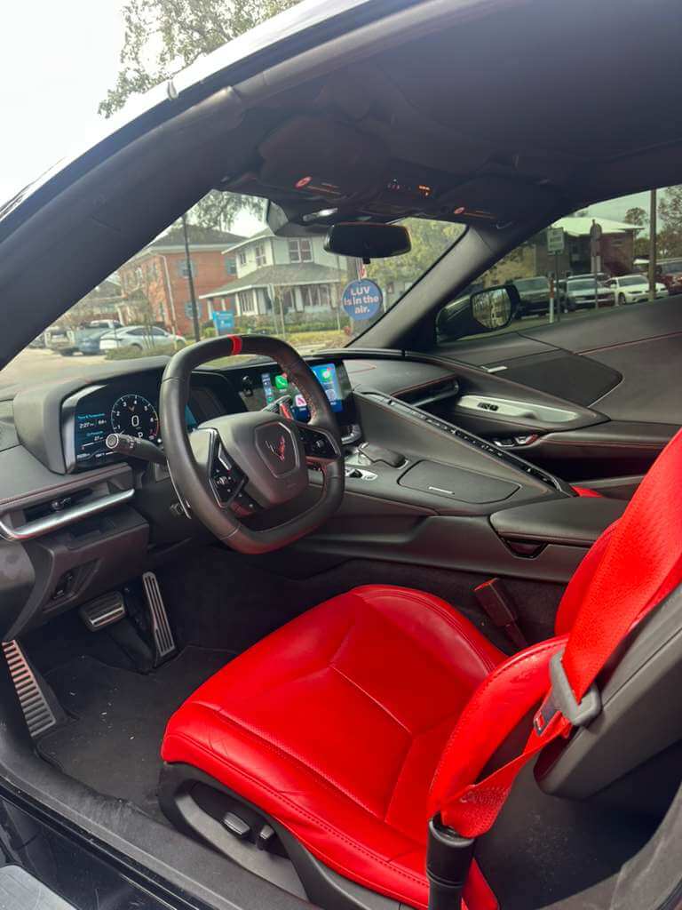 2023 Corvette C8 interior showcasing red seats and modern dashboard features.