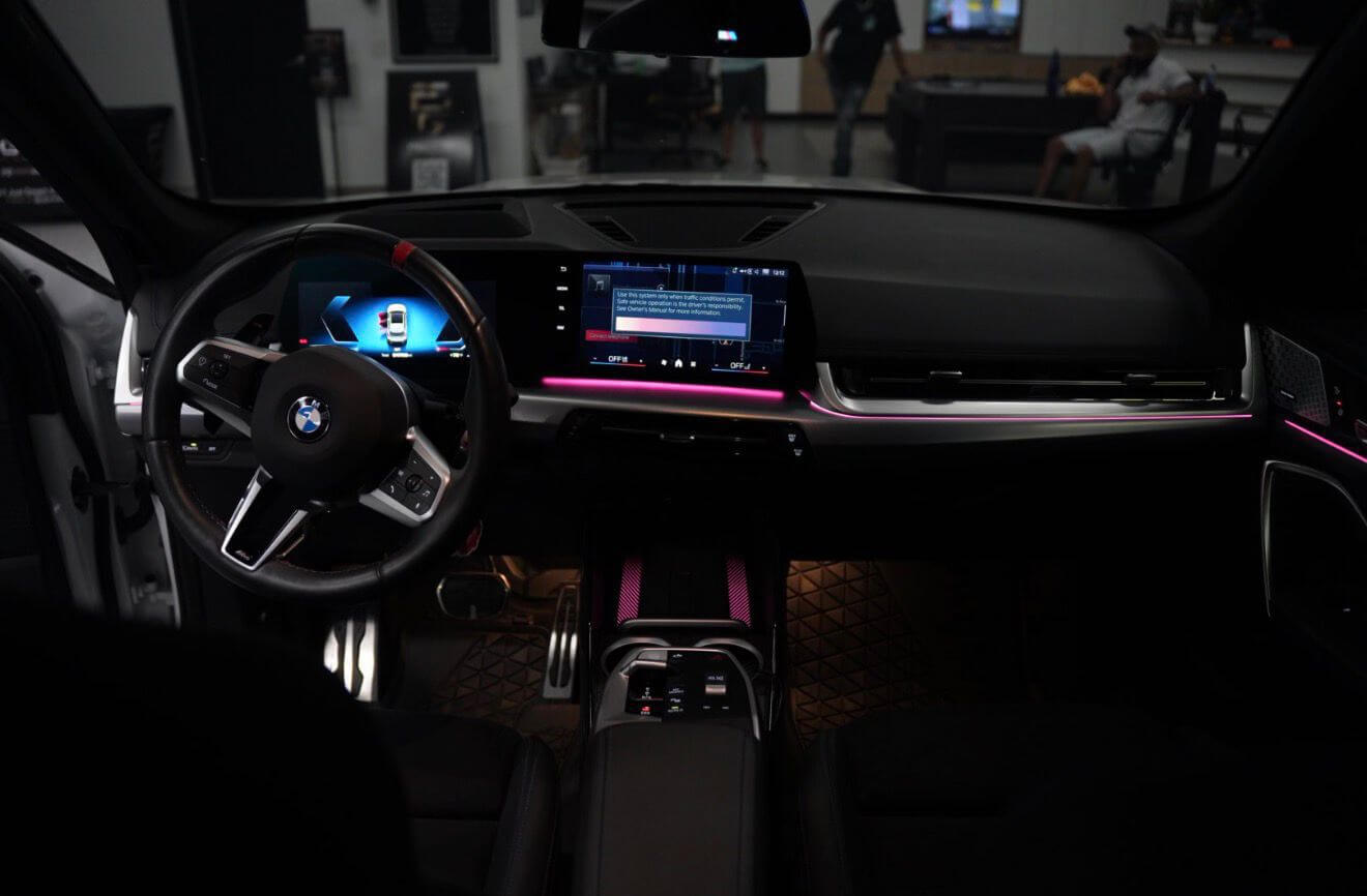 Interior view of the 2024 BMW X1 M35i showcasing the luxurious dashboard and advanced technology.