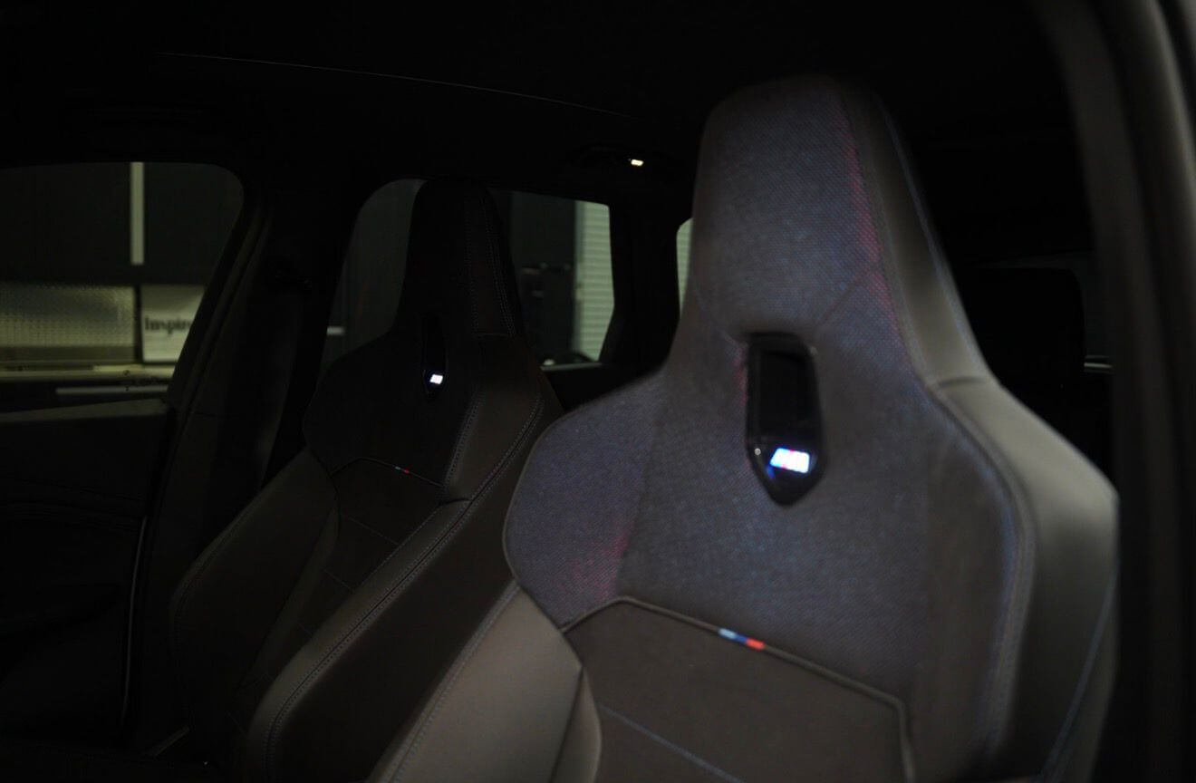 2024 BMW X1 M35i interior showing luxurious front sport seats with M branding.