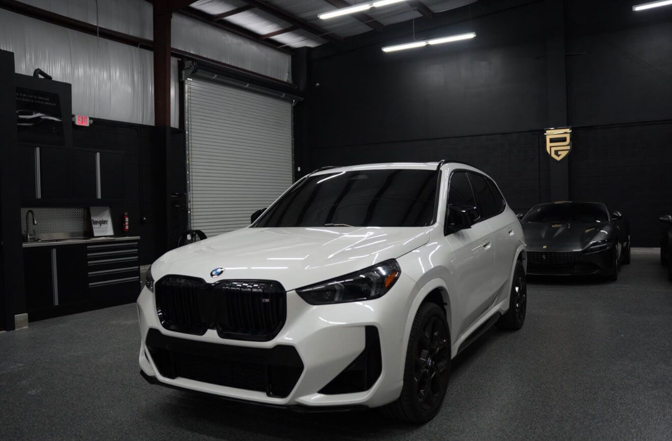2024 BMW X1 M35i parked inside a showroom with sleek design and luxury features.