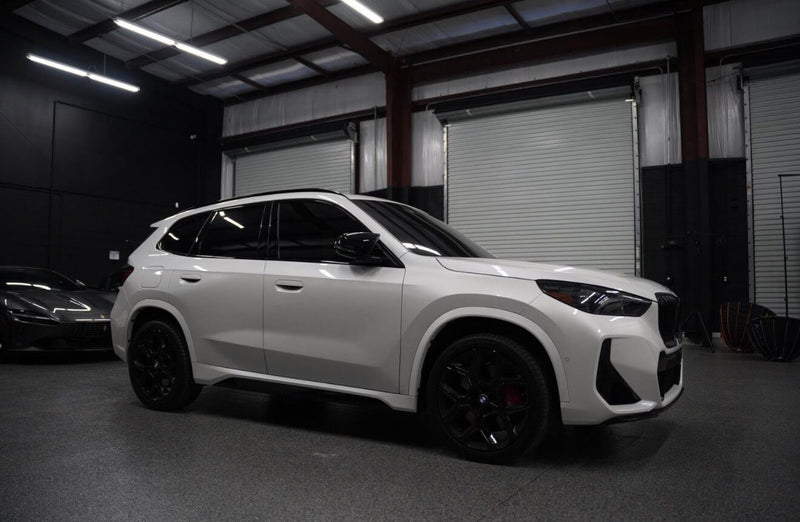 2024 BMW X1 M35i parked indoors showcasing luxury features and bold design.