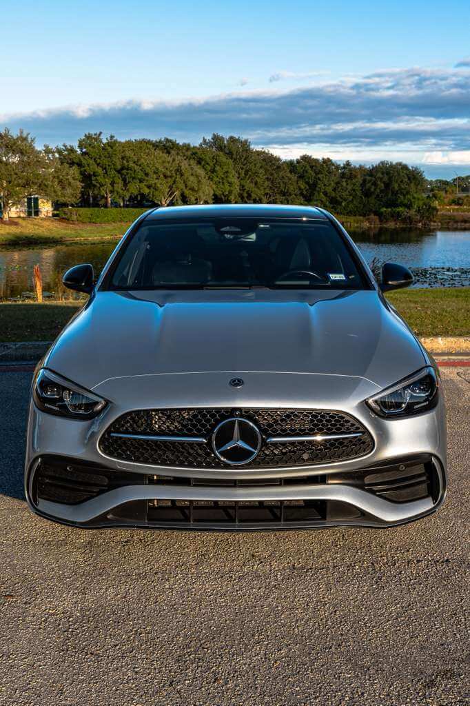 2024 Mercedes C300 front view showcasing luxury and performance by the water.