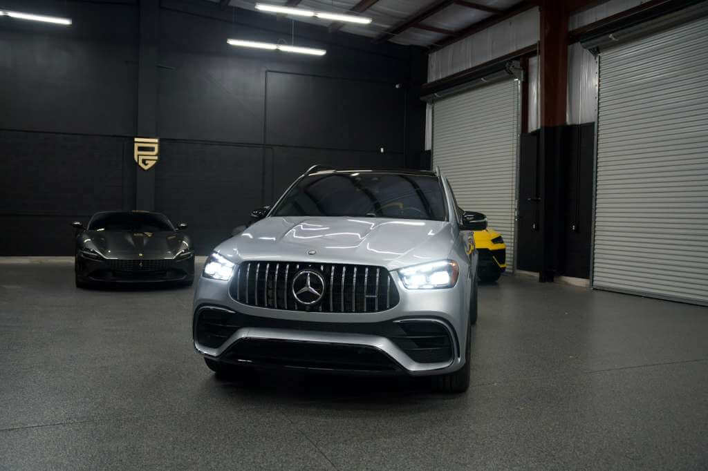 2024 Mercedes GLE 63S displayed in a luxury car showroom with sleek lighting and modern design.