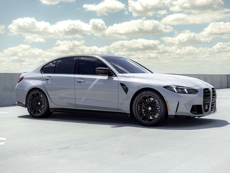 2026 BMW M3 Competition in a parking lot showcasing sleek design and performance features.