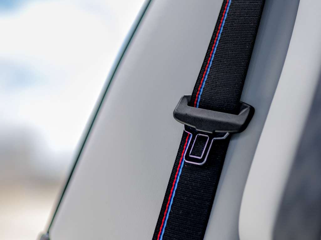 2026 BMW M3 Competition seatbelt featuring the signature M colors for safety and style.