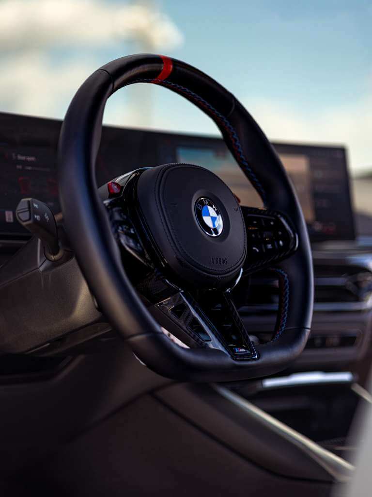2026 BMW M3 Competition interior steering wheel with sporty design and performance features.