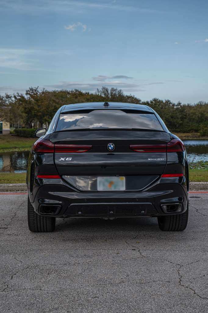 2026 BMW X6 rear view showcasing its luxury design and bold silhouette in a scenic Orlando setting.
