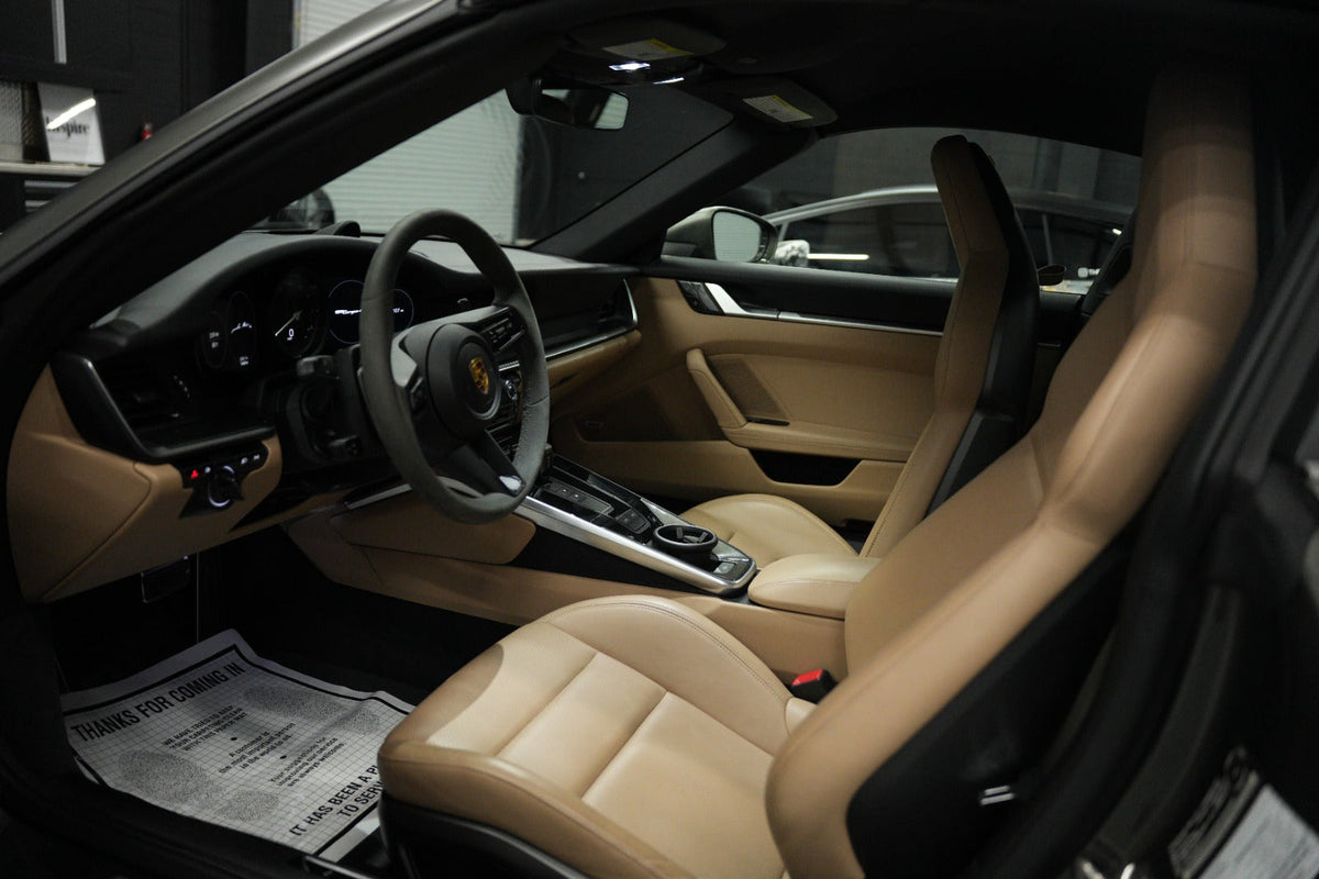 Interior view of a luxury sports car with tan leather seats, modern ...