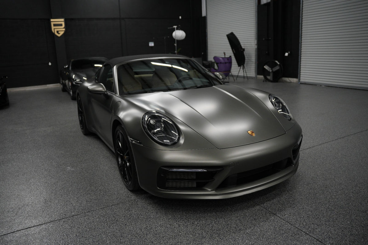 Porsche 911 Targa side view showing the iconic Targa roll bar and retractable roof available for rental in Orlando