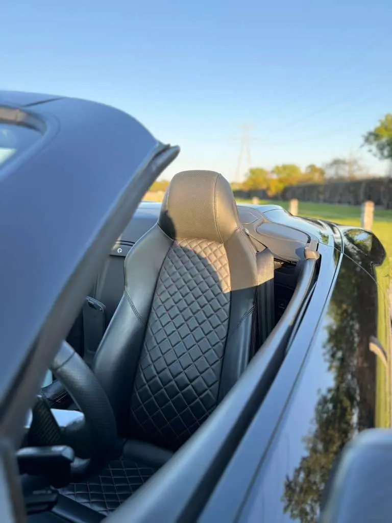Black quilted leather car seat interior in a luxury convertible sports ...