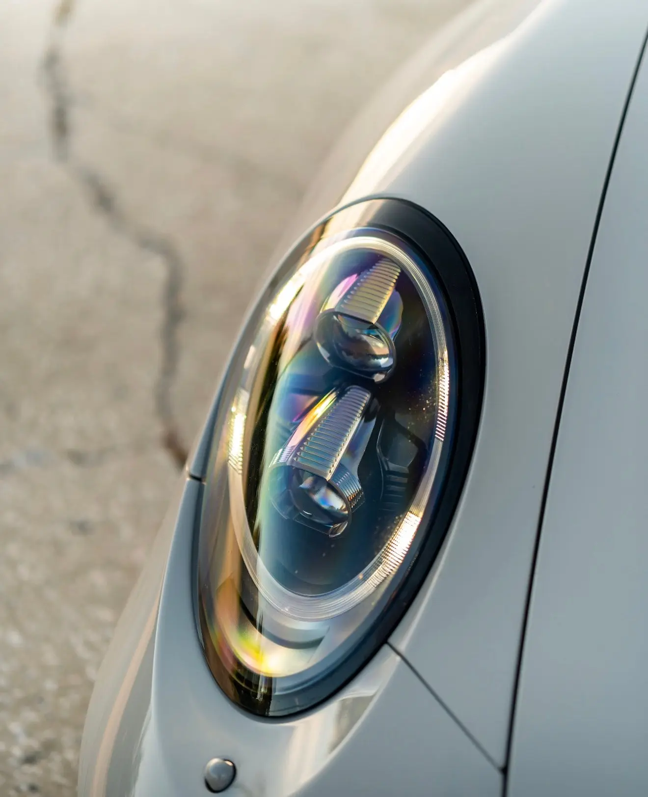 Close-up of a sleek car LED headlight on a silver sports car, showcasing modern automotive lighting design and high-quality craftsmanship.