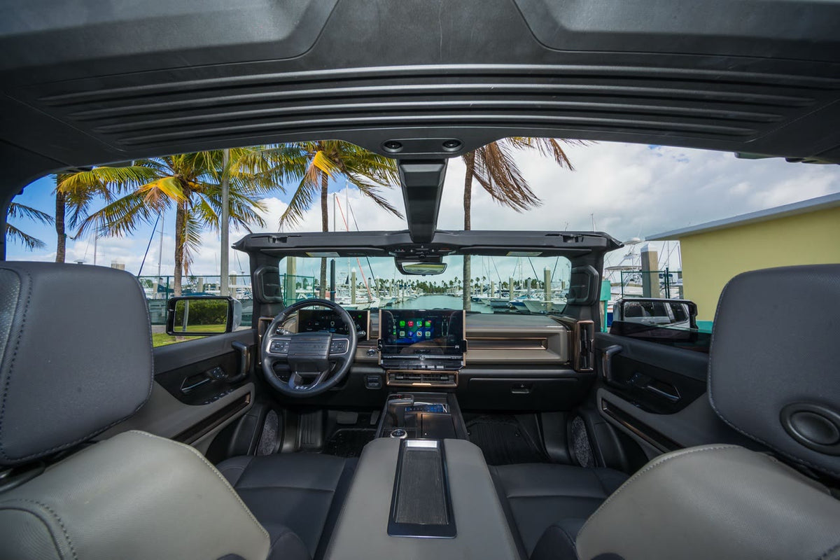View through the GMC Hummer EV SUV cabin with the roof panels removed