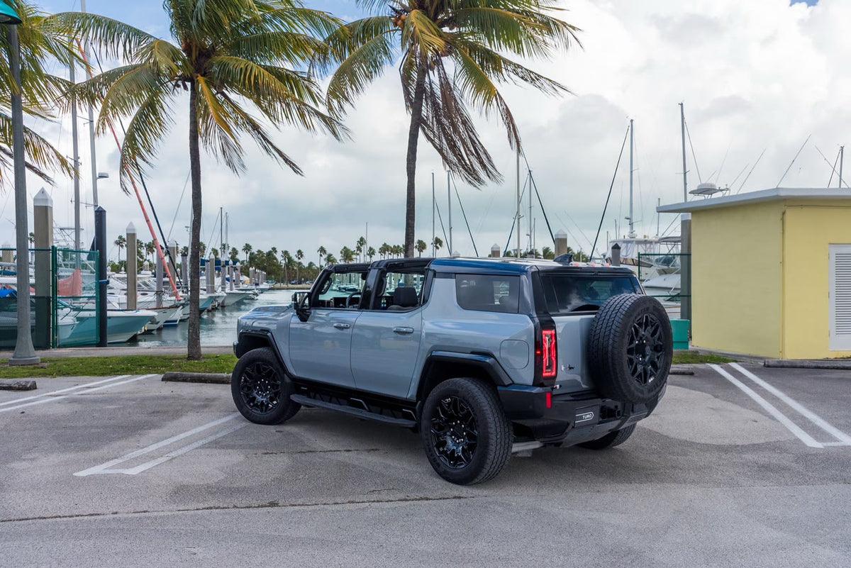 GMC Hummer EV SUV rear three-quarter view with the tailgate-mounted spare wheel