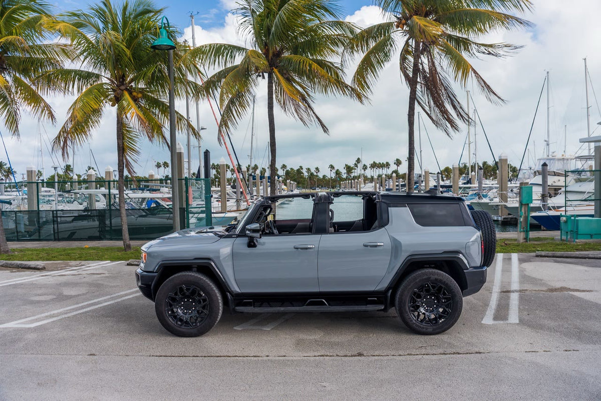 GMC Hummer EV SUV side profile with the Infinity Roof open and the spare tire mounted