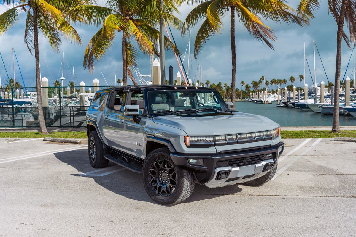 GMC Hummer EV SUV with the Infinity Roof panels removed, parked at a Florida marina